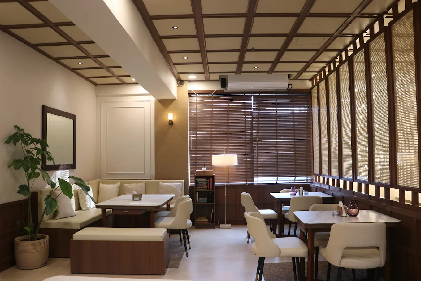 Cafe OneTen indoor seating with warm wooden tones and pendant lamps